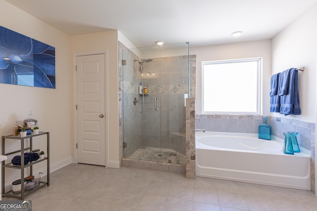 bathroom with tile patterned flooring and shower with separate bathtub