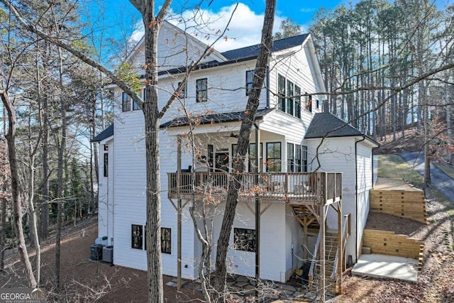 back of property featuring ceiling fan, a wooden deck, and cooling unit