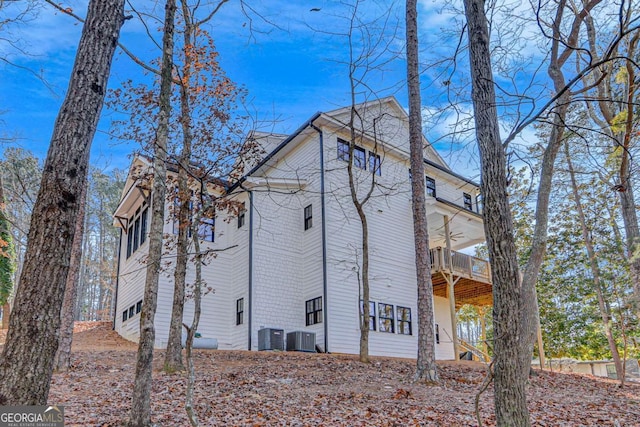 view of side of home featuring a balcony and cooling unit