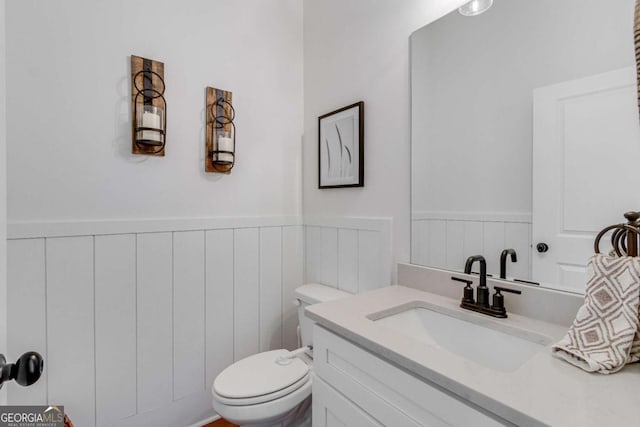 bathroom featuring toilet and vanity