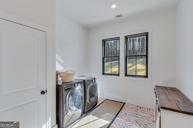 laundry room with cabinets and washing machine and dryer