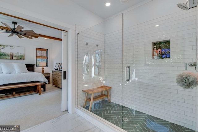 bathroom with a shower with door, ceiling fan, and beamed ceiling