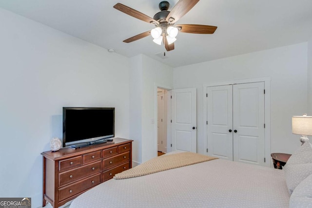 bedroom featuring ceiling fan and a closet