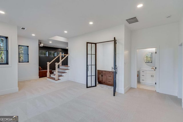 basement featuring light colored carpet