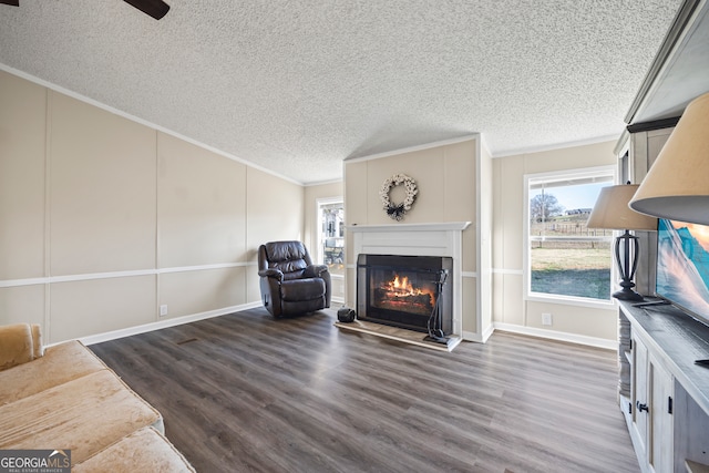 living room featuring ornamental molding, a wealth of natural light, and dark hardwood / wood-style floors