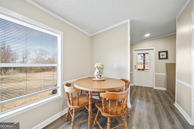 dining space featuring lofted ceiling, dark hardwood / wood-style flooring, a textured ceiling, and crown molding