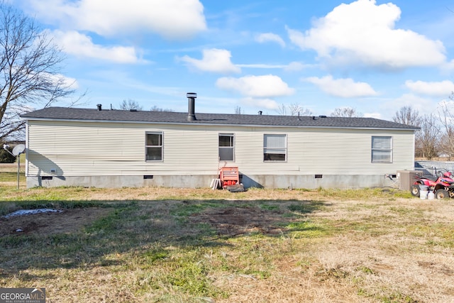 rear view of house with a yard