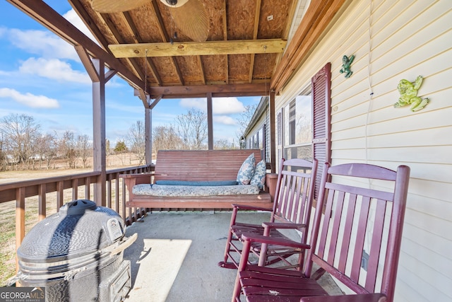 view of patio with grilling area and a wooden deck