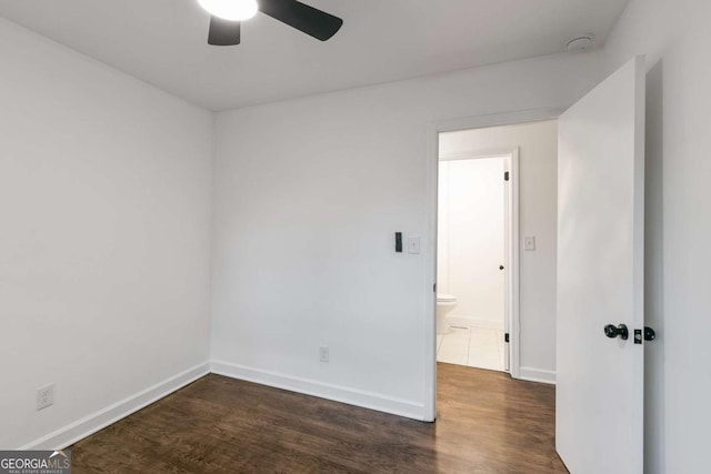 unfurnished room featuring ceiling fan and dark hardwood / wood-style floors