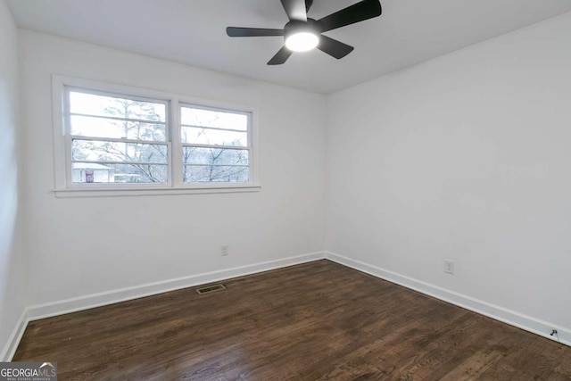 empty room with ceiling fan and dark hardwood / wood-style floors