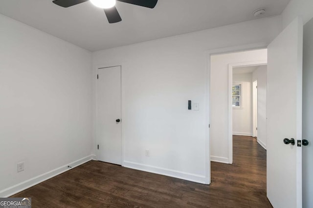 spare room featuring dark hardwood / wood-style flooring and ceiling fan