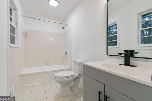 full bathroom with vanity, toilet, tile patterned floors, and tiled shower / bath