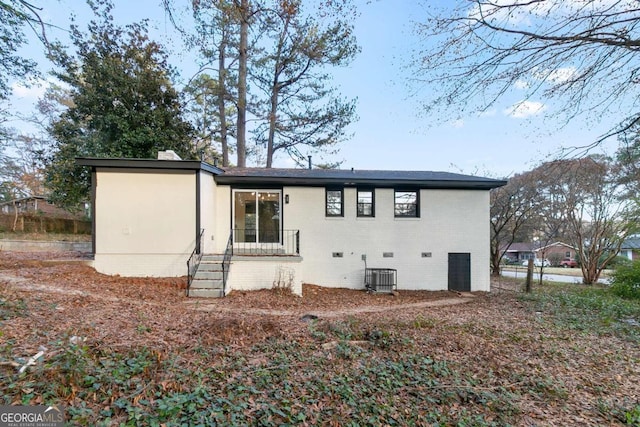 rear view of house with central AC