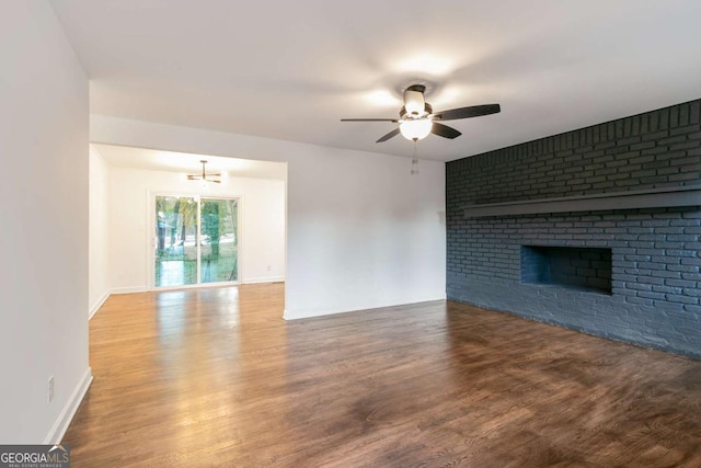 unfurnished living room with a brick fireplace, ceiling fan, and hardwood / wood-style flooring