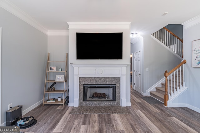 unfurnished living room featuring ornamental molding and wood-type flooring