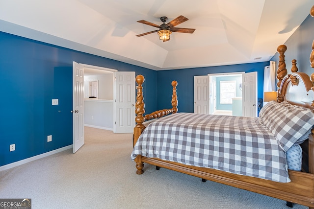 carpeted bedroom featuring ceiling fan and a raised ceiling