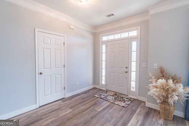 entrance foyer featuring hardwood / wood-style flooring and crown molding