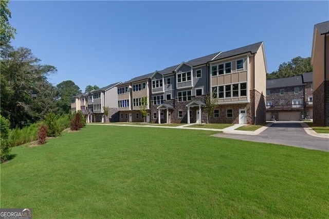 rear view of house featuring a yard