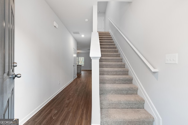 staircase featuring wood-type flooring