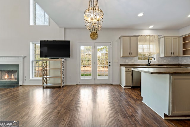 kitchen featuring dark hardwood / wood-style flooring, decorative backsplash, a chandelier, and hanging light fixtures