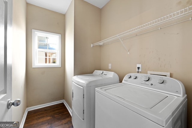 clothes washing area featuring washer and dryer and dark hardwood / wood-style flooring