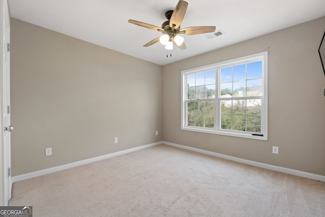 unfurnished room with ceiling fan and light carpet