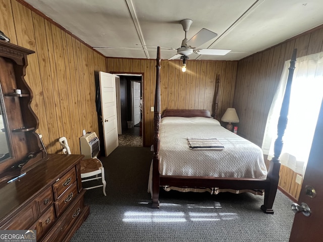 carpeted bedroom with wood walls and ceiling fan