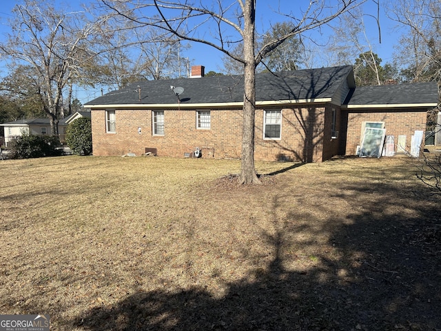 rear view of property featuring a yard