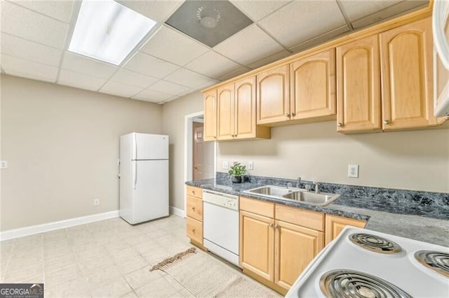 kitchen with white appliances, light brown cabinetry, a drop ceiling, and sink