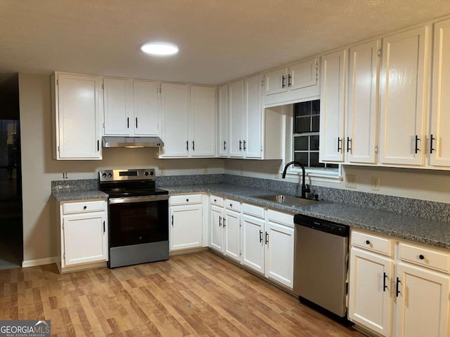 kitchen featuring stainless steel appliances, white cabinetry, and sink