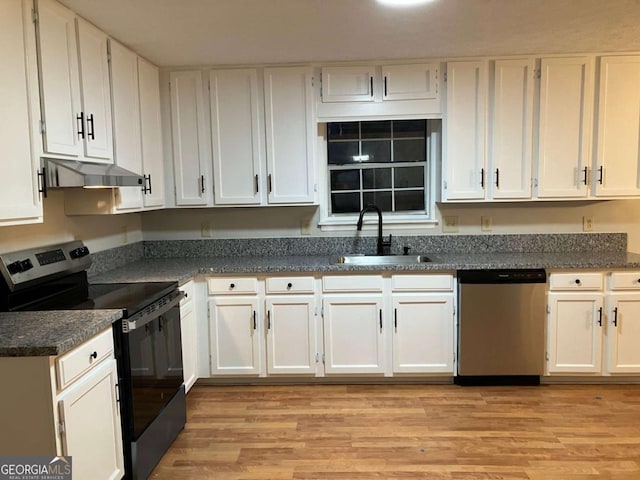 kitchen with stainless steel appliances, white cabinets, sink, and light wood-type flooring