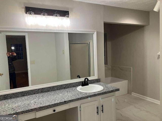 bathroom featuring plus walk in shower and vanity