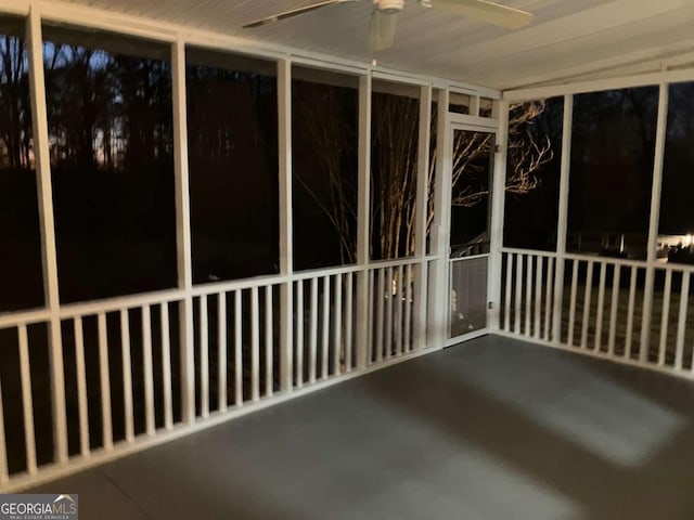 unfurnished sunroom with ceiling fan