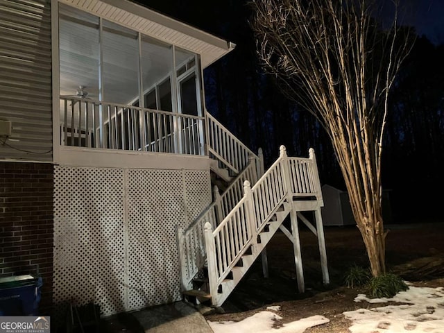 exterior space featuring ceiling fan and a sunroom