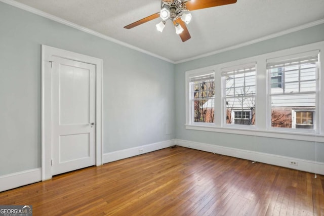 empty room with ceiling fan, hardwood / wood-style floors, ornamental molding, and a textured ceiling