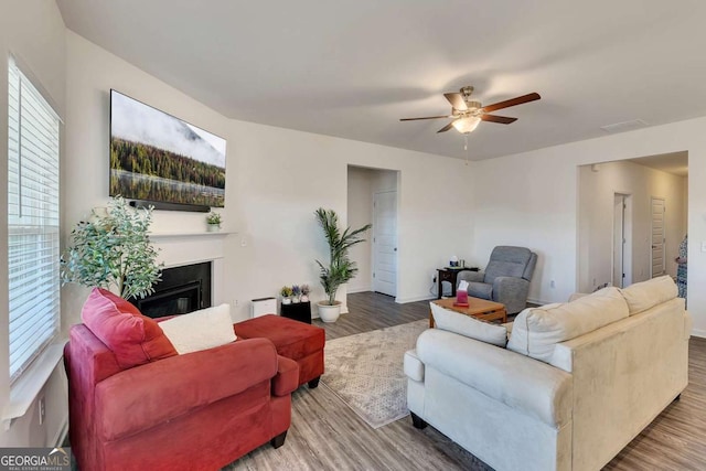 living room featuring ceiling fan and hardwood / wood-style floors