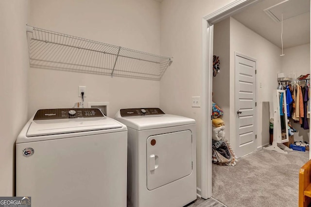 laundry area with washing machine and dryer and light colored carpet