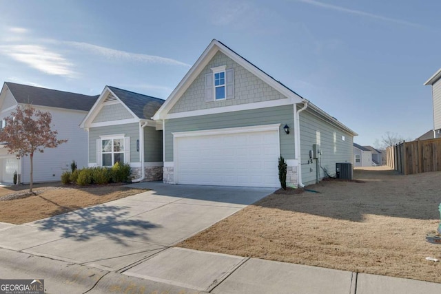 view of front of house with central AC unit and a garage