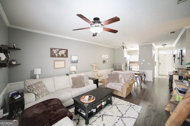 living room with dark hardwood / wood-style flooring, ornamental molding, and ceiling fan