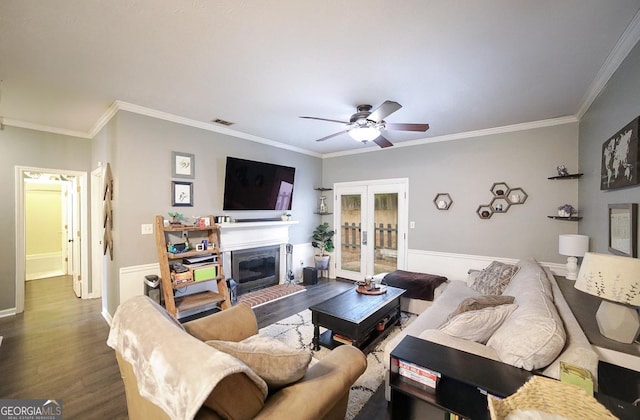 living room with hardwood / wood-style floors, ornamental molding, and ceiling fan