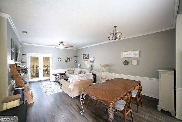 dining area with dark hardwood / wood-style flooring, french doors, crown molding, and ceiling fan with notable chandelier