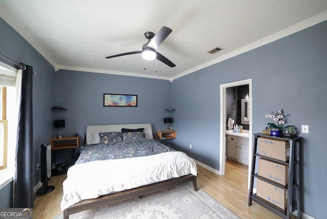 bedroom with ceiling fan, light hardwood / wood-style floors, connected bathroom, and crown molding