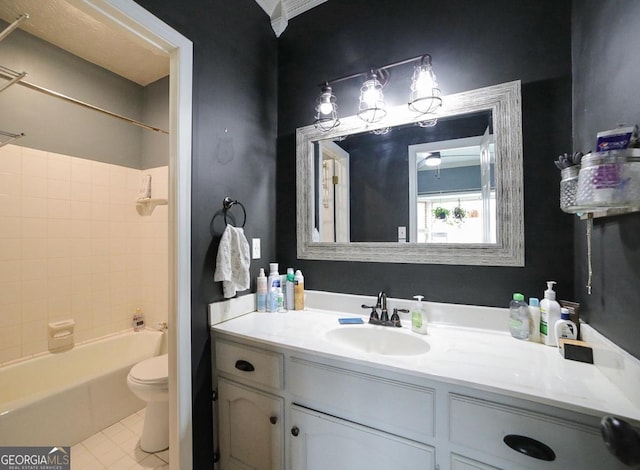 full bathroom featuring vanity, tile patterned flooring, toilet, and tiled shower / bath combo