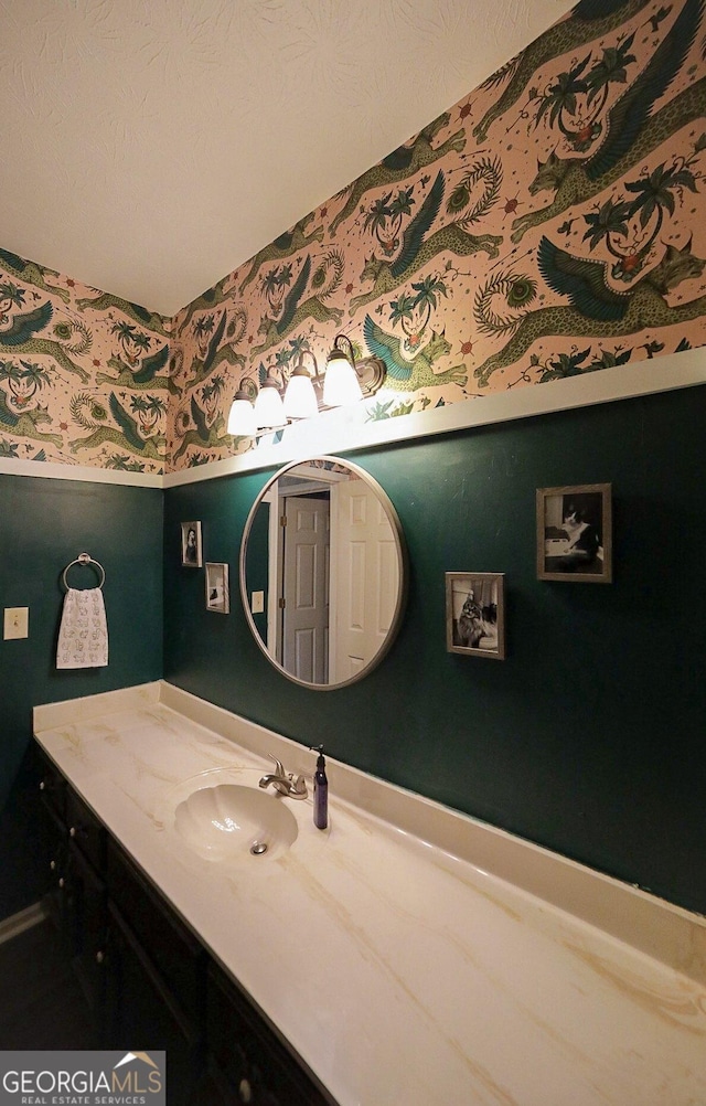 bathroom with a textured ceiling and vanity