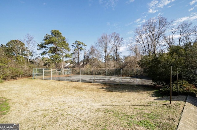 view of yard featuring basketball hoop