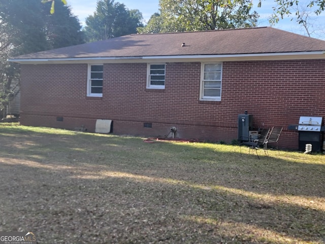 rear view of property featuring a yard