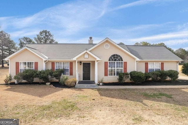 single story home with a front lawn