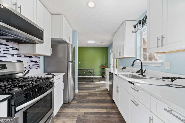 kitchen with white cabinets, stainless steel appliances, and sink