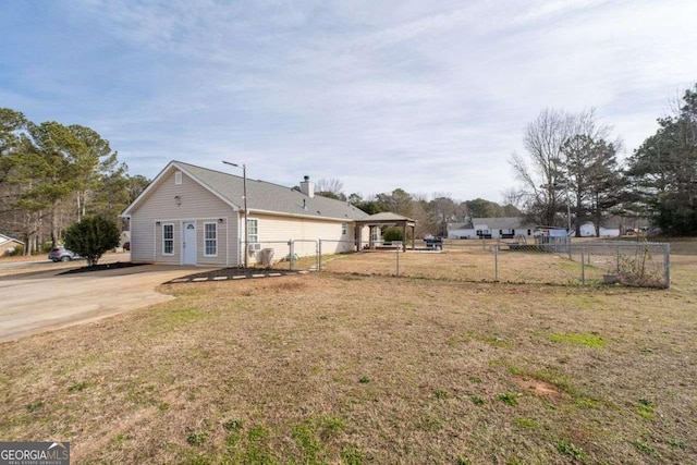 view of side of property with a lawn