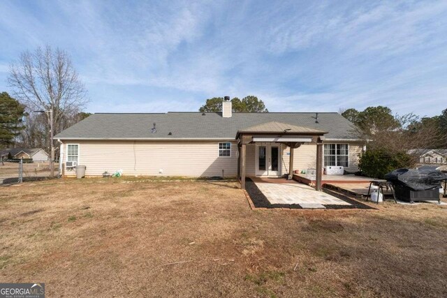 back of house with a patio area and a yard